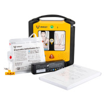 VIVEST AED kit including the main yellow defibrillator unit, sealed electrode pads, a battery pack, and an instruction booklet.