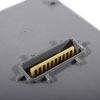 a close up of a connector to attach the grey plastic battery to the defibrillator 