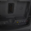 A close-up of the battery connection port on the back of a dark grey defibrillator