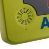 A close-up of the speaker on a bright green defibrillator