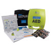 A bright yellow defibrillator with all its contents spread out