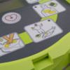 A close-up of the defibrillator screen with user instructions